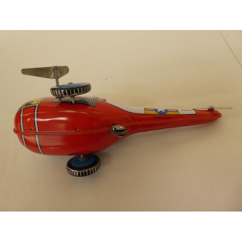 213 - Three Dinky diecast model aeroplanes and a car; and a Chinese made tinplate clockwork 'Rescue-Helico... 