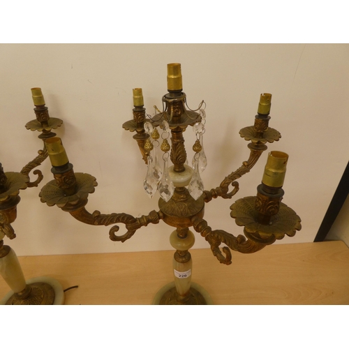 226 - A pair of gilt metal and onyx, five branch candelabra  22