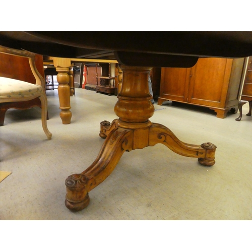 233 - An early Victorian quarter burr walnut veneered centre table, raised on a bulbous column and carved ... 