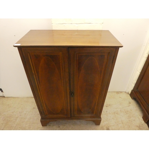 24 - An Edwardian mahogany two door side cabinet, raised on bracket feet  41