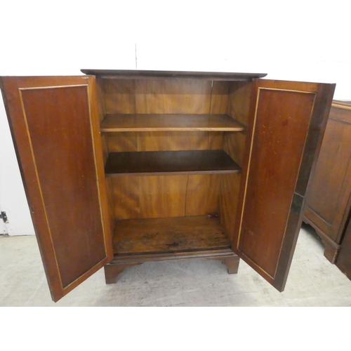 24 - An Edwardian mahogany two door side cabinet, raised on bracket feet  41