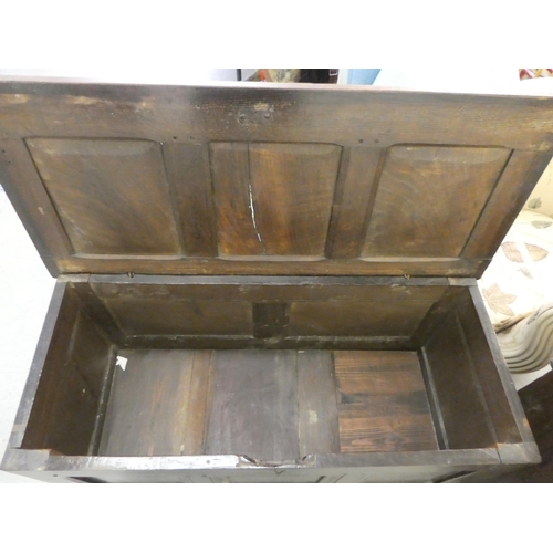 244 - A mid 18thC panelled oak coffer with straight sides and a hinged lid, raised on straight legs  ... 