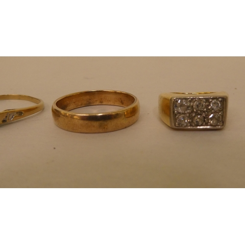 267 - A gold coloured metal wedding ring; another gold coloured metal pave set diamond ring; a 14ct white ... 