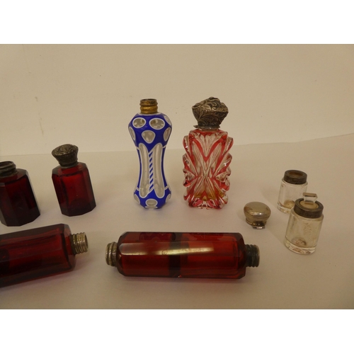 275 - Various late 19thC coloured glass scent bottles; some with silver caps  various designs 