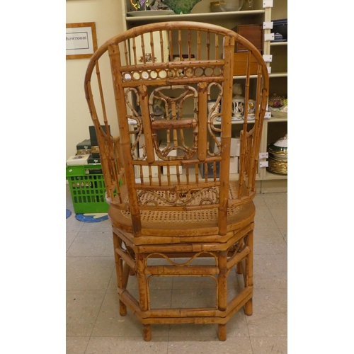 279 - A mid 20thC Brighton Pavilion design bamboo chair with swept open arms and a caned seat, raised on t... 