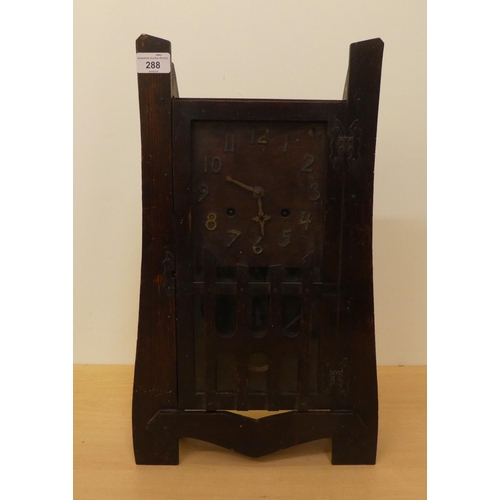 288 - An early 20thC Arts & Crafts oak cased mantel clock; the 8 day movement faced by an Arabic dial ... 