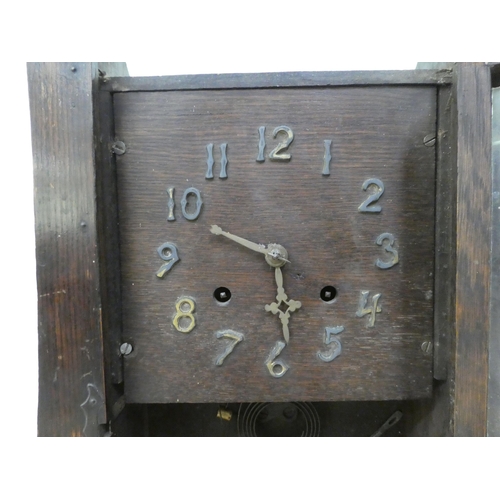 288 - An early 20thC Arts & Crafts oak cased mantel clock; the 8 day movement faced by an Arabic dial ... 