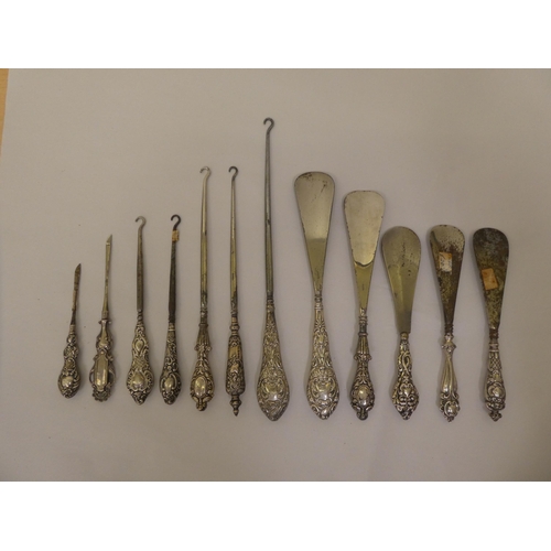 298 - Victorian and later steel button hooks and shoe horns, on decoratively moulded silver handles  ... 