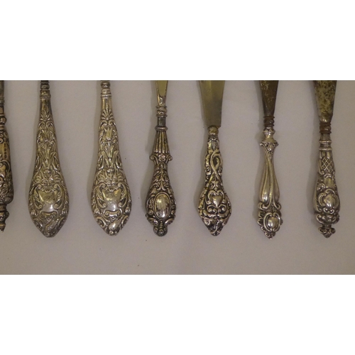 298 - Victorian and later steel button hooks and shoe horns, on decoratively moulded silver handles  ... 