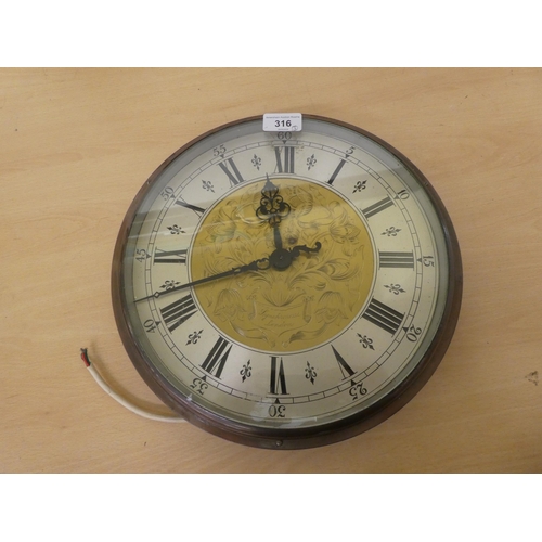 316 - Clocks: to include a cast metal Synclock electric example, faced by a Roman dial  13