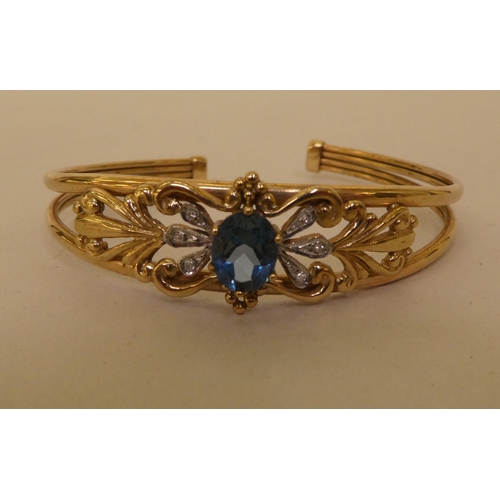 334 - A 9ct gold topaz and diamond open end bangle