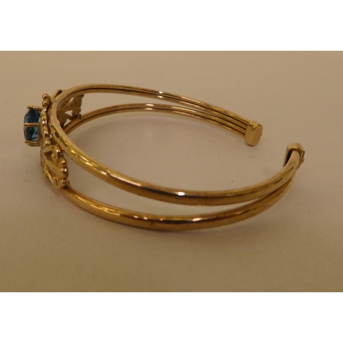 334 - A 9ct gold topaz and diamond open end bangle