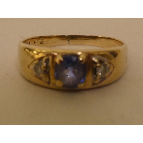 335 - An 18ct gold diamond and blue stone gypsy design ring