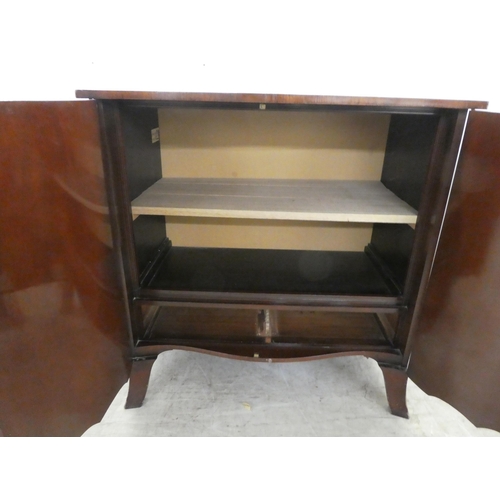 37 - An Edwardian crossbanded yew and mahogany serpentine front, two door cabinet, enclosing two open she... 