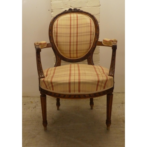 42 - A 20thC French inspired, carved mahogany framed open arm salon chair, raised on fluted forelegs