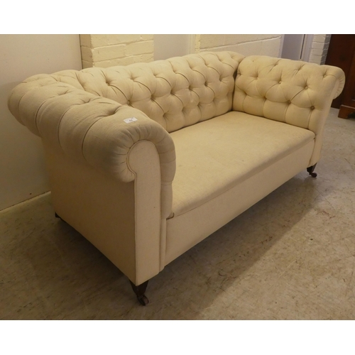 44 - A mid 19thC and later fabric upholstered, drop-end Chesterfield, raised on square legs and casters  ... 