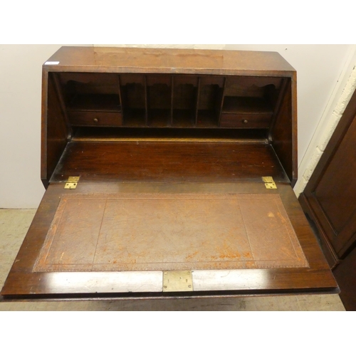 47 - A 1930s burr walnut finished bureau, the fall-flap over three drawers, raised on shell carved cabrio... 