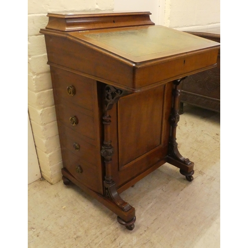 51 - A late Victorian mahogany Davenport, having a sloping, hinged lid with a tooled green hide scriber, ... 