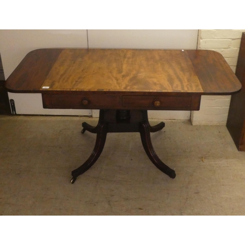 53 - A Regency ebony inlaid mahogany sofa table with two frieze drawers, raised on splayed, sabre legs an... 