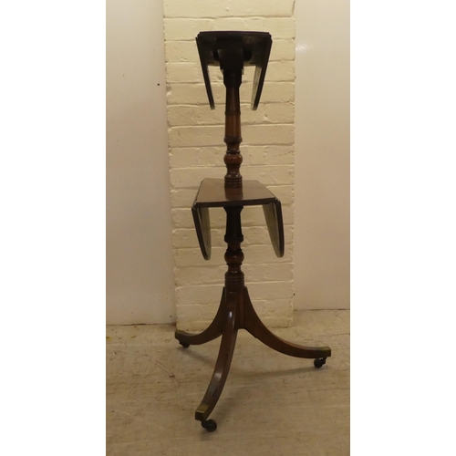 56 - A George III mahogany dumb waiter with two tiers, raised on a pedestal tripod base and casters  39