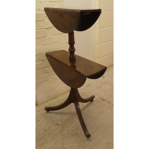 56 - A George III mahogany dumb waiter with two tiers, raised on a pedestal tripod base and casters  39