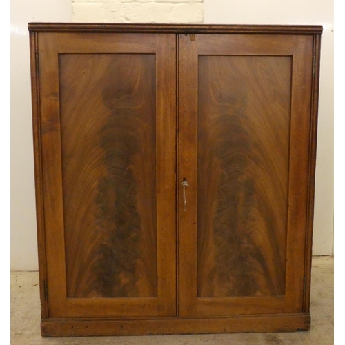 59 - A George III mahogany two door side cabinet with a pair of panelled doors, on a plinth  34