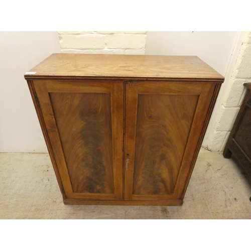 59 - A George III mahogany two door side cabinet with a pair of panelled doors, on a plinth  34