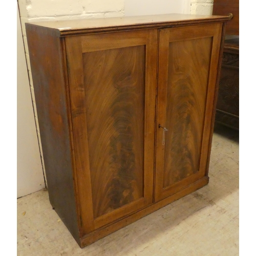 59 - A George III mahogany two door side cabinet with a pair of panelled doors, on a plinth  34