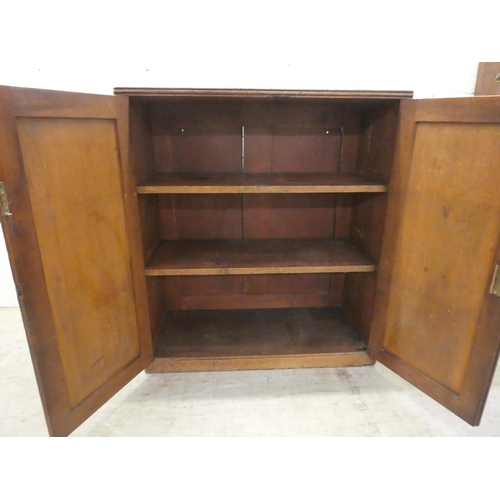 59 - A George III mahogany two door side cabinet with a pair of panelled doors, on a plinth  34