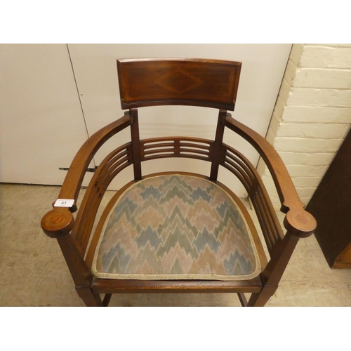 61 - An Edwardian satinwood inlaid mahogany, horseshoe shaped chair with a slatted back, raised on square... 