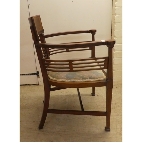 61 - An Edwardian satinwood inlaid mahogany, horseshoe shaped chair with a slatted back, raised on square... 