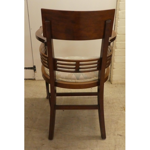 61 - An Edwardian satinwood inlaid mahogany, horseshoe shaped chair with a slatted back, raised on square... 