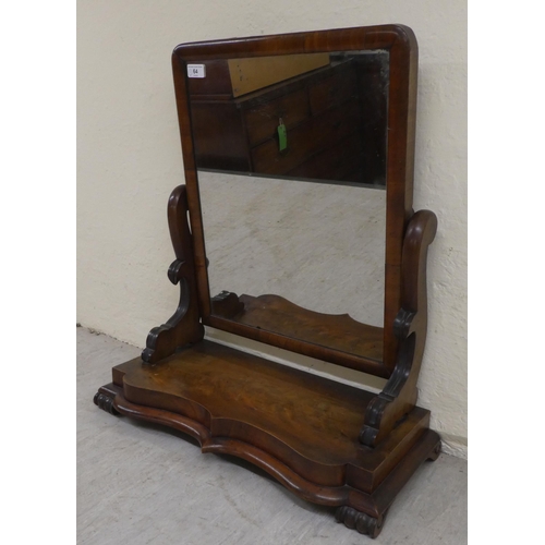 64 - A mid Victorian mahogany framed dressing table mirror, on a stepped serpentine front plinth  24... 