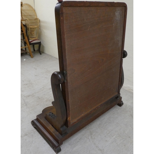 64 - A mid Victorian mahogany framed dressing table mirror, on a stepped serpentine front plinth  24... 