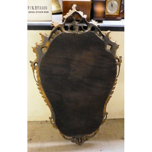 67 - A modern rococo design mirror, in an ornate gilded frame  36