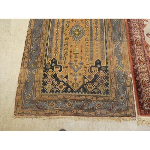 75 - Rugs: to include a Persian example with a central gul, on a red ground  82