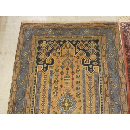 75 - Rugs: to include a Persian example with a central gul, on a red ground  82