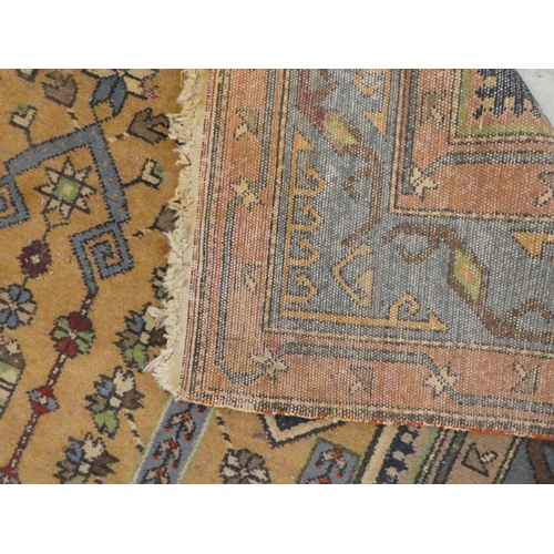 75 - Rugs: to include a Persian example with a central gul, on a red ground  82