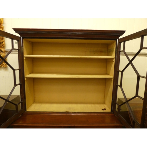 76 - An Edwardian mahogany cabinet bookcase, the upper section with two glazed doors, over two panelled d... 