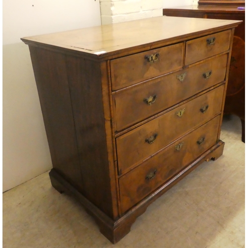 8 - A late 18thC crossbanded and quarter veneered, mahogany five drawer dressing chest, on a plinth and ... 