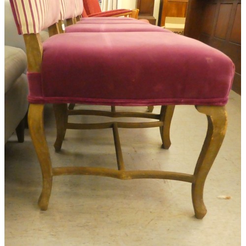 248 - A set of four limed, washed oak framed and two pink fabric patterned upholstered dining chairs, rais... 