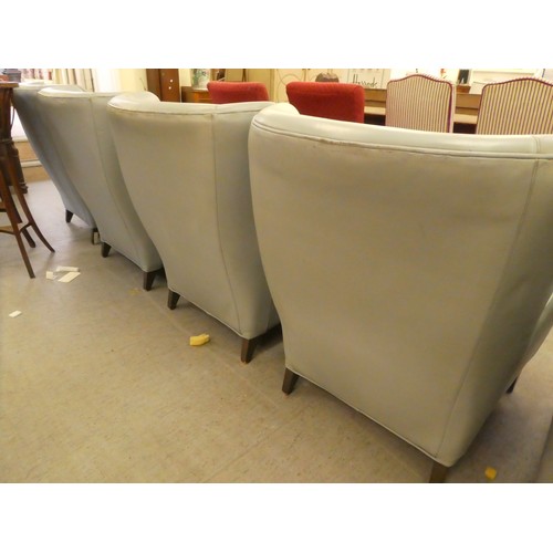 245 - A set of five modern Morgan Furniture, grey hide upholstered enclosed armchairs, raised on square, t... 