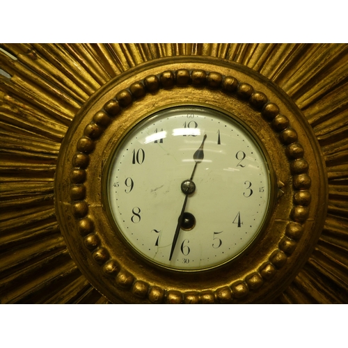 127 - An early 20thC gilded gesso sunburst wall clock; the movement faced by an enamelled Arabic dial  26