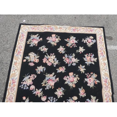 182 - A 20thC wool tapestry, depicting roses, on a black ground  71