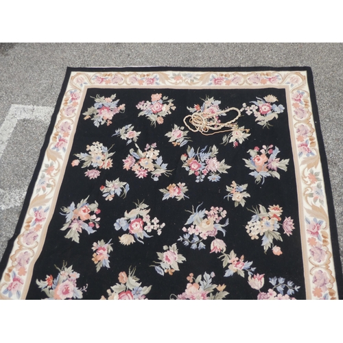 182 - A 20thC wool tapestry, depicting roses, on a black ground  71