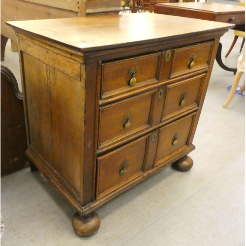 234 - A late 18th/early 19thC oak three drawer dressing chest, on a plinth and turned bun feet  32