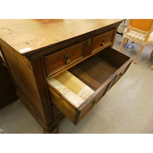 234 - A late 18th/early 19thC oak three drawer dressing chest, on a plinth and turned bun feet  32