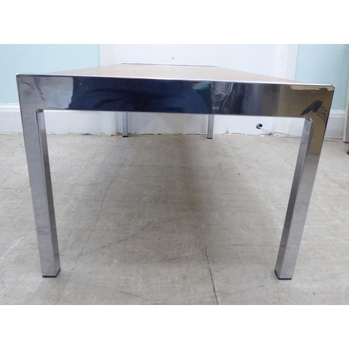 104 - A 1980s oak coffee table, raised on chromium plated ends and square legs  bears an indistinct stamp ... 