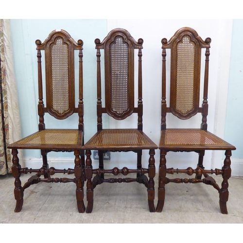 105 - A set of six early/mid 20thC oak framed traditional English style dining chairs with caned backs and... 