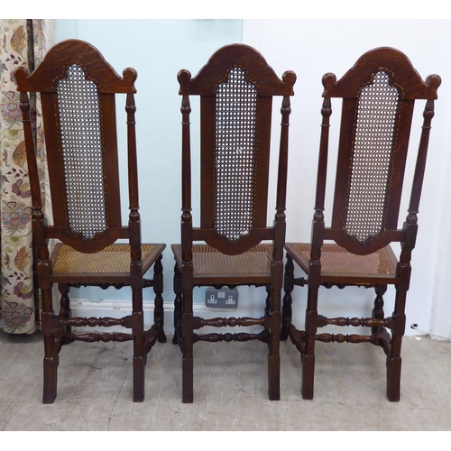 105 - A set of six early/mid 20thC oak framed traditional English style dining chairs with caned backs and... 